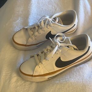 Nike White and Black Sneakers with Gold Stripe